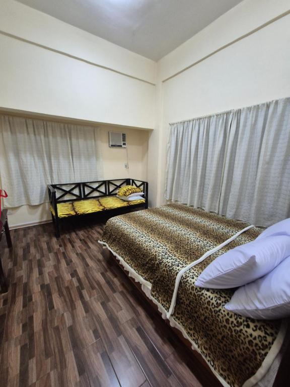 a bedroom with two beds and a window at Heart Haven Retreat in Sipalay