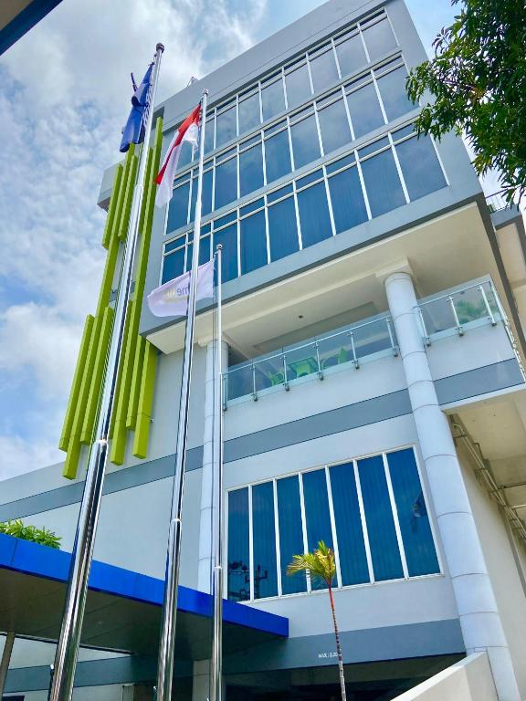 a building with flags in front of it at PrimeBiz Tegal in Tegal