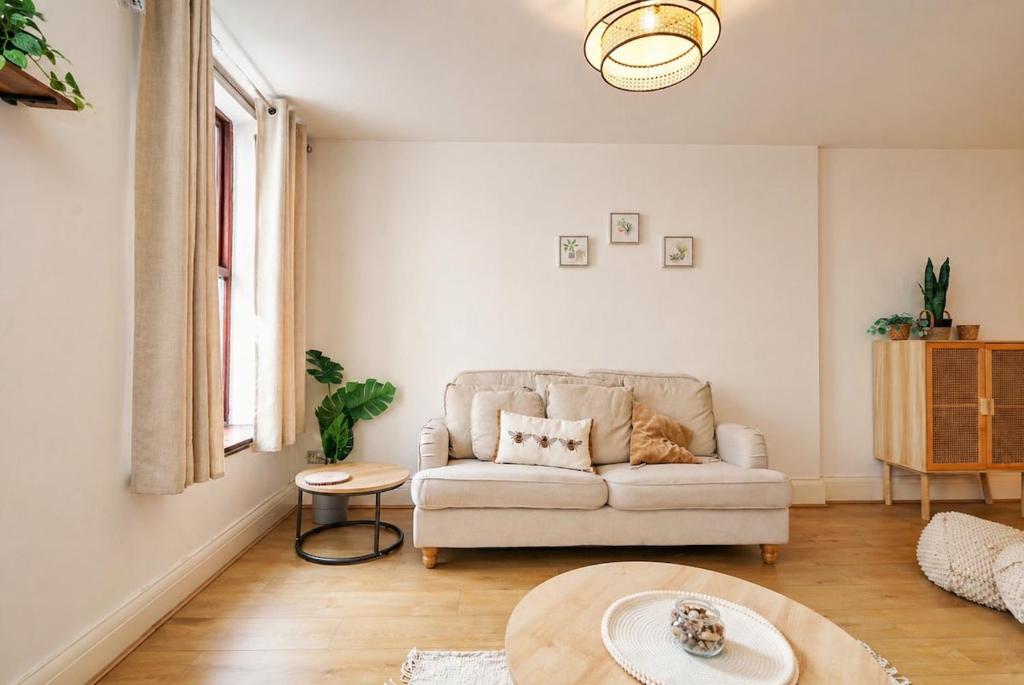 a living room with a couch and a table at The MCR Prime Pad in Manchester