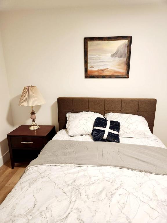 a bed with a bow tie on top of it at Serene Luxury Suite in Riverview