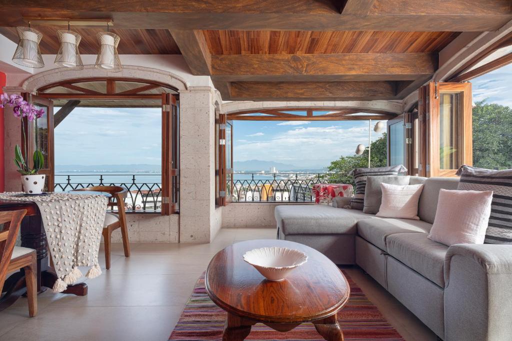 a living room with a couch and a table at Marcela Resort & Spa in Puerto Vallarta