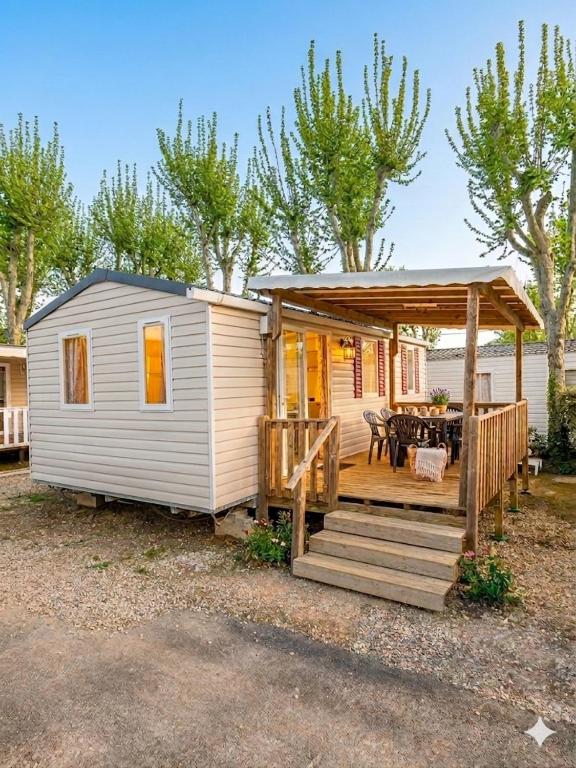 a tiny house with a porch and a deck at Les sables du midi in Valras-Plage