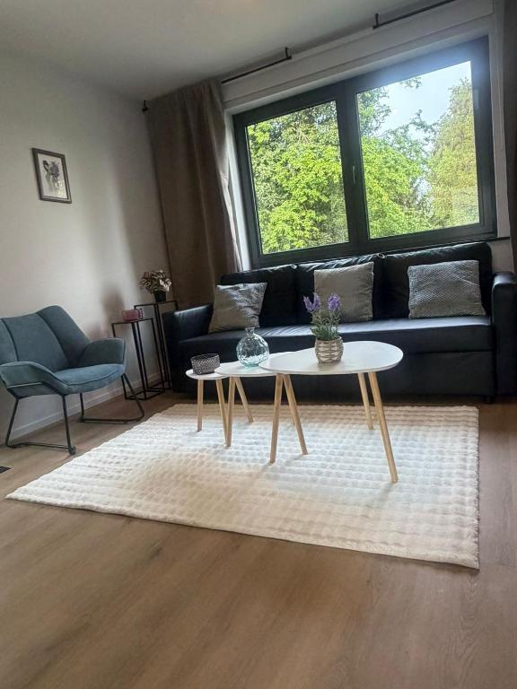 a living room with a couch and a coffee table at Secret garden 3 in Mellehoek