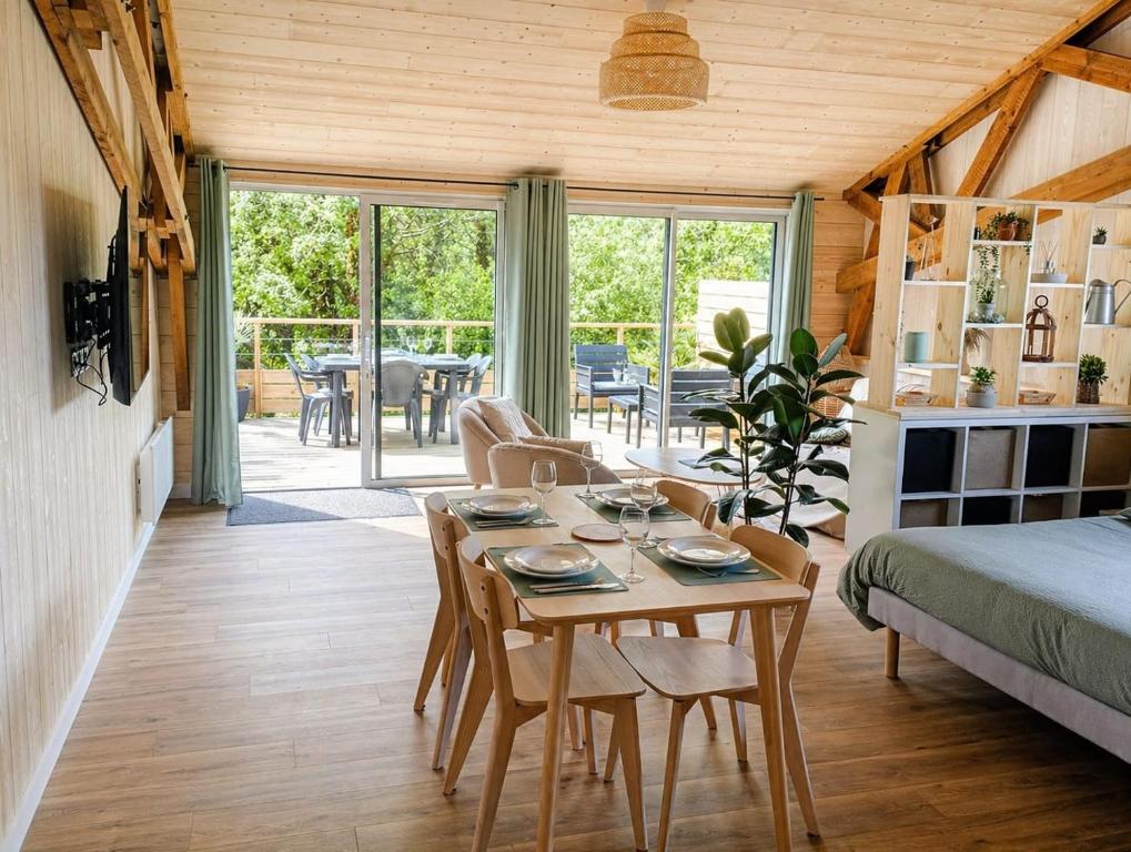 a room with a table and chairs and a bed at ty loft keremma in Tréflez