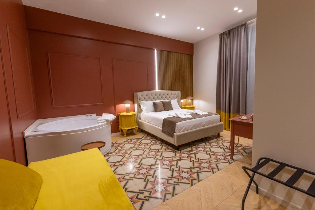 a hotel room with a bed and a bath tub at Palazzo Sospiri in Bisceglie