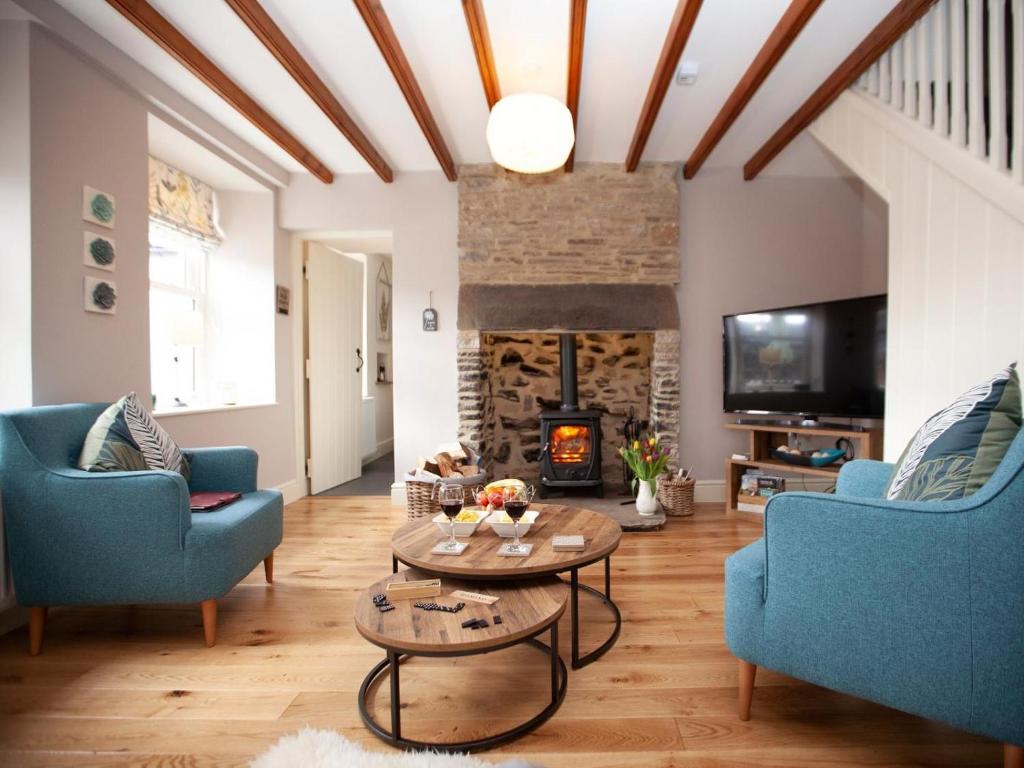 a living room with blue chairs and a fireplace at 2 Bed in Richmond oc-74284 in Reeth