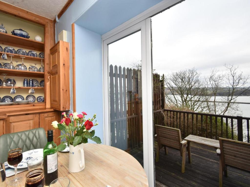 a dining room with a table and a large window at 1 Bed in Goodwick oc-fb274 in Goodwick