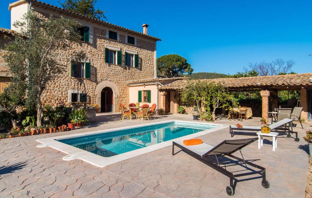 a house with a swimming pool in front of a building at Frontera in Sóller
