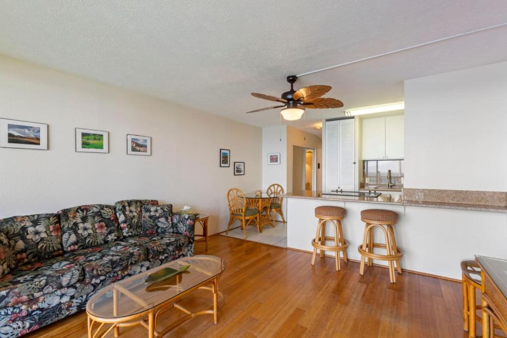 a living room with a couch and a table at Maalaea Banyans Oceanfront in Wailuku