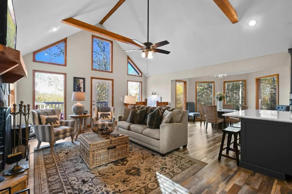 a living room with a couch and a table at Hillside Happiness GameRoom Grill Firepit MORE in Sevierville