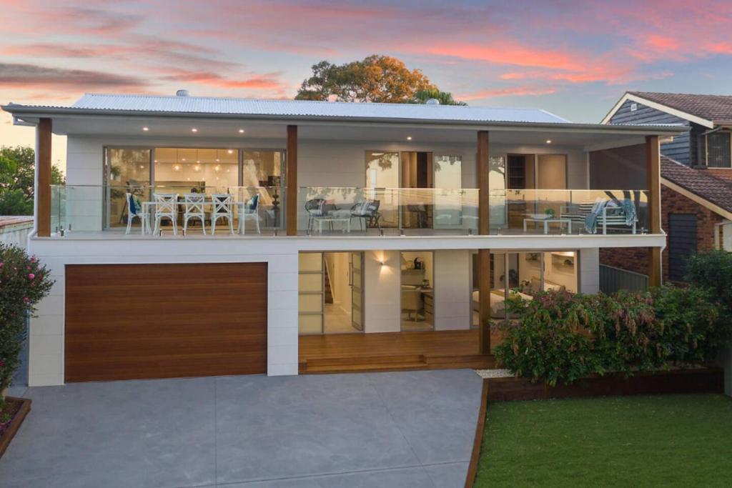 a large house with a lot of windows at Lakeview Luxury in Budgewoi