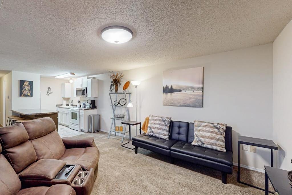 a living room with a couch and a table at Escape to Notch Estates in Branson West