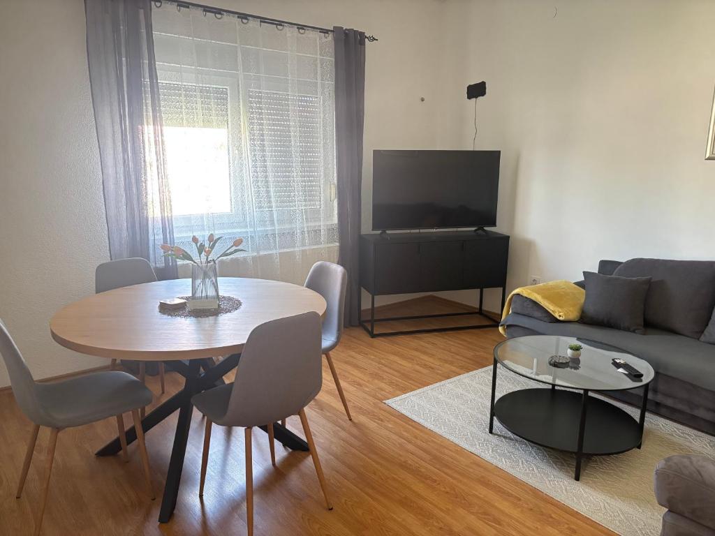 a living room with a table and a couch at Vacation home Ivana in Vukovar