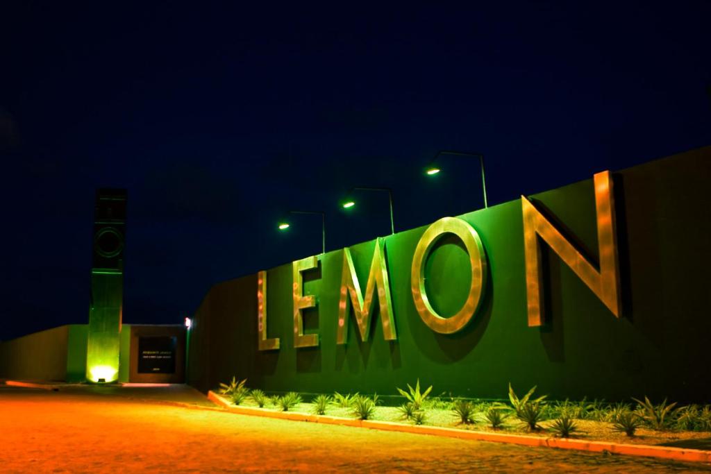 a large sign on the side of a building at night at Lemon Motel- Afogados in Recife