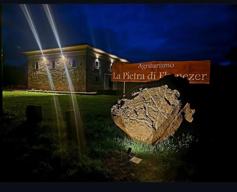 a building with a large rock in front of it at La Pietra di Ebenezer in Filetto
