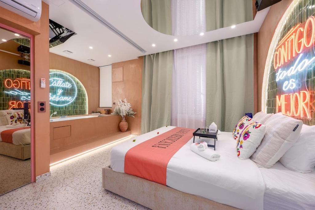 a hotel room with a large bed and a sign at La Casa Mexicana in Alfortville