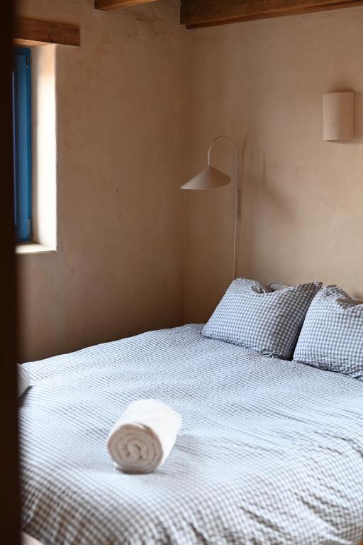 a bed with a pillow on top of it at Fazenda Azul in Budens