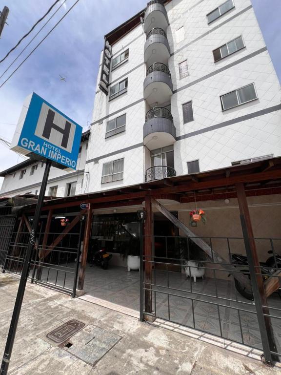 a building with a sign in front of it at Hotel Gran Imperio la 69 in Medellín