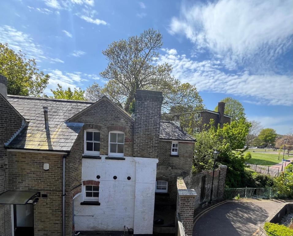 a brick house with a gate and a driveway at St Marys Cottage 2 in Dover
