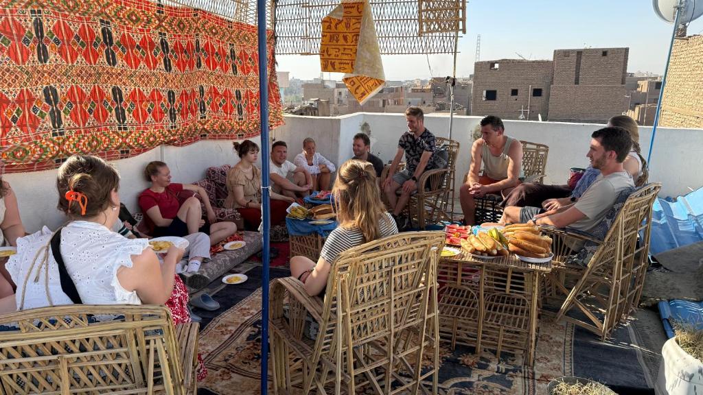 a group of people sitting around a table at Grand Square Hostel Luxor in Luxor