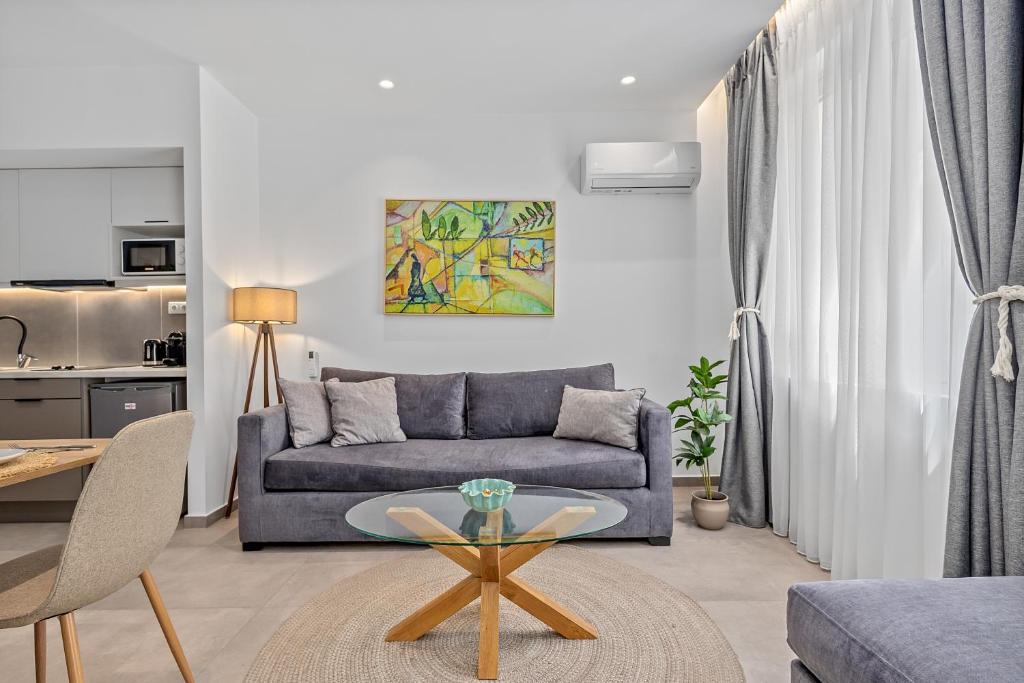 a living room with a couch and a table at Athens Theatrou Apartments in Athens
