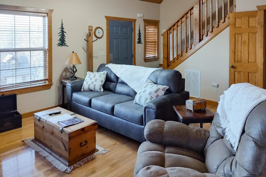 a living room with a couch and a table at Beautiful Branson in Branson West