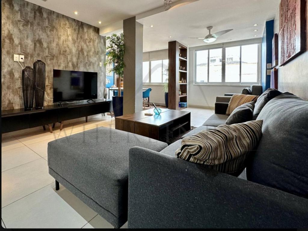 a living room with two couches and a television at Best 2 bedroom condo 3 bathroom in Rio de Janeiro