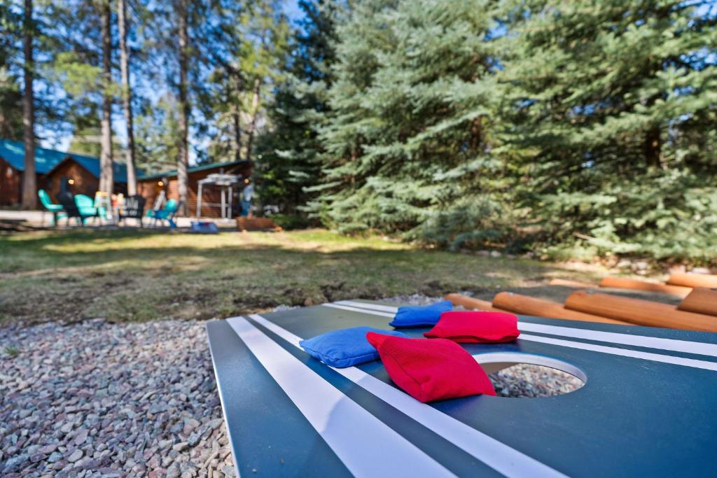 a picnic table with red and blue pillows on it at Glacier Cabins in Martin City