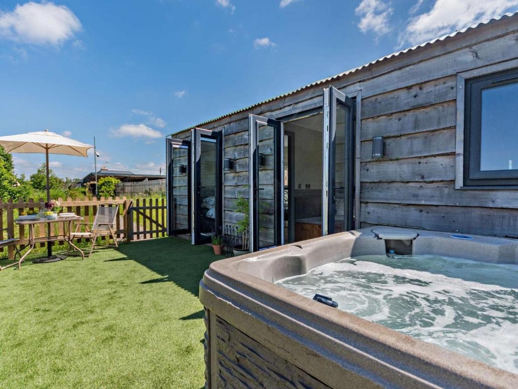 a hot tub in the backyard of a house at 1 Bed in Hawarden oc-93595 in Hawarden