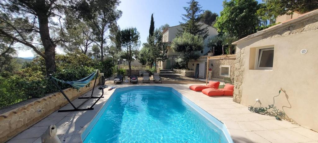 a swimming pool in the backyard of a house at Villa Palama in Marseille