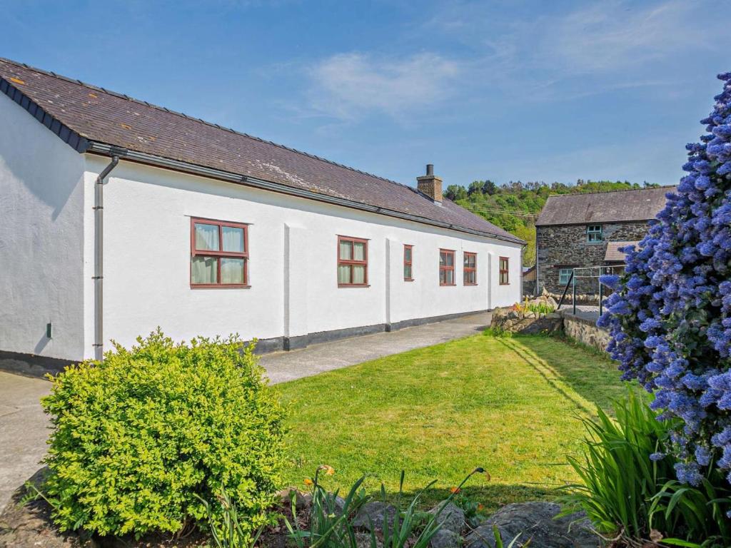a white house with a garden in front of it at 3 Bed in Conwy oc-95906 in Conwy