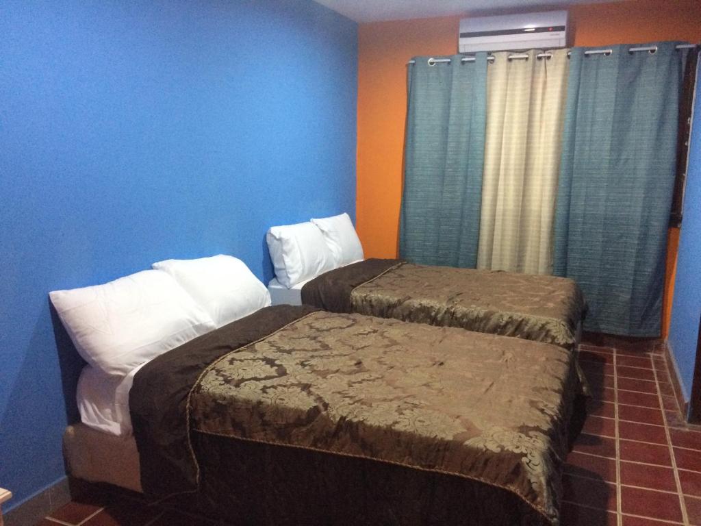 מיטה או מיטות בחדר ב-Coco Blue Resort