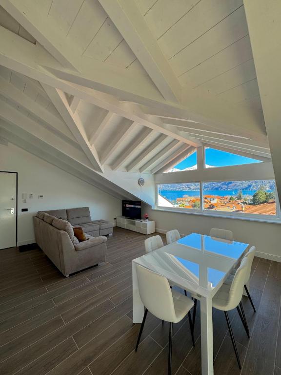 a living room with a table and a couch at Apt. Aries - Penthouse Menaggio in Menaggio