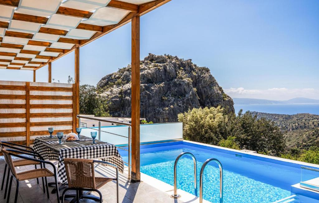 a villa with a pool and a table and chairs at Thyme 1 in Agia Galini