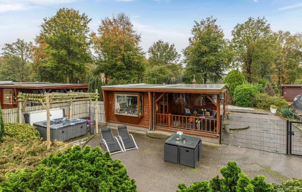 a tiny house in a garden with two chairs at Nice Home In Erm With Wifi in Erm