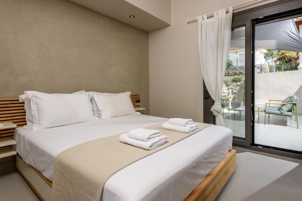 a bedroom with a large bed with towels on it at The Old Port in Limenas