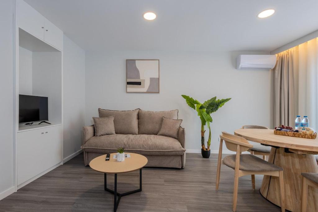 a living room with a couch and a table at Azor Signature Flats - III in Ponta Delgada