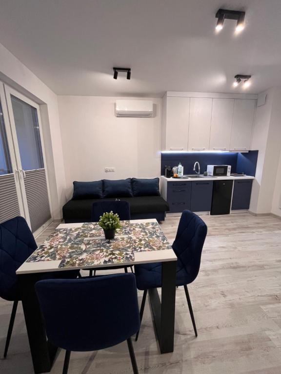 a living room with a table and a couch at Apartament Raj in Biała Podlaska