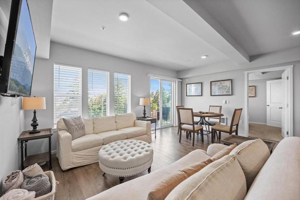 a living room with a couch and a table at Steps to Dome Breathtaking views parking AC! in Tacoma