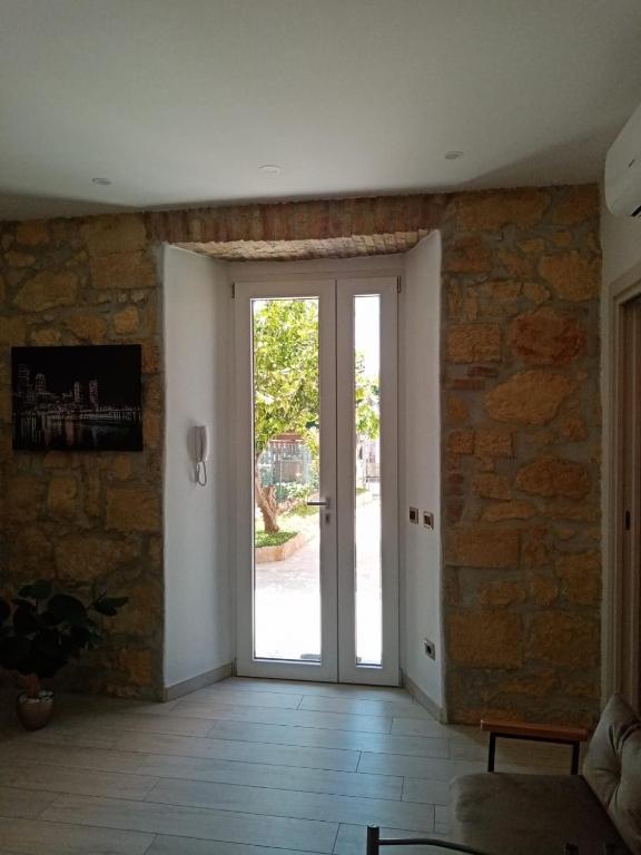 an open door in a room with a stone wall at Casa De Grazia in Tarquinia