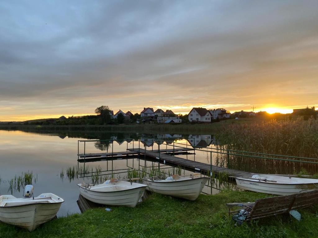 a group of boats parked next to a dock at Apartamenty u Rybaka in Stężyca