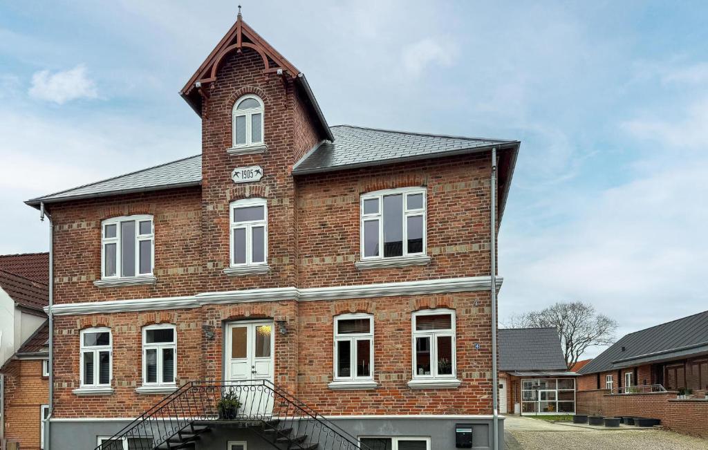 a brick building with a clock tower on it at Nice Home In Ansager With Wifi in Ansager