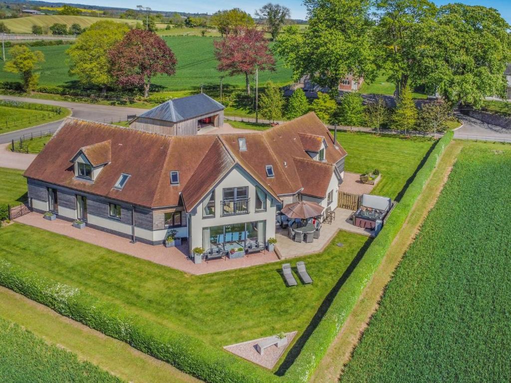 an aerial view of a large house with a roof at 5 Bed in Hereford oc-78646 in Madley