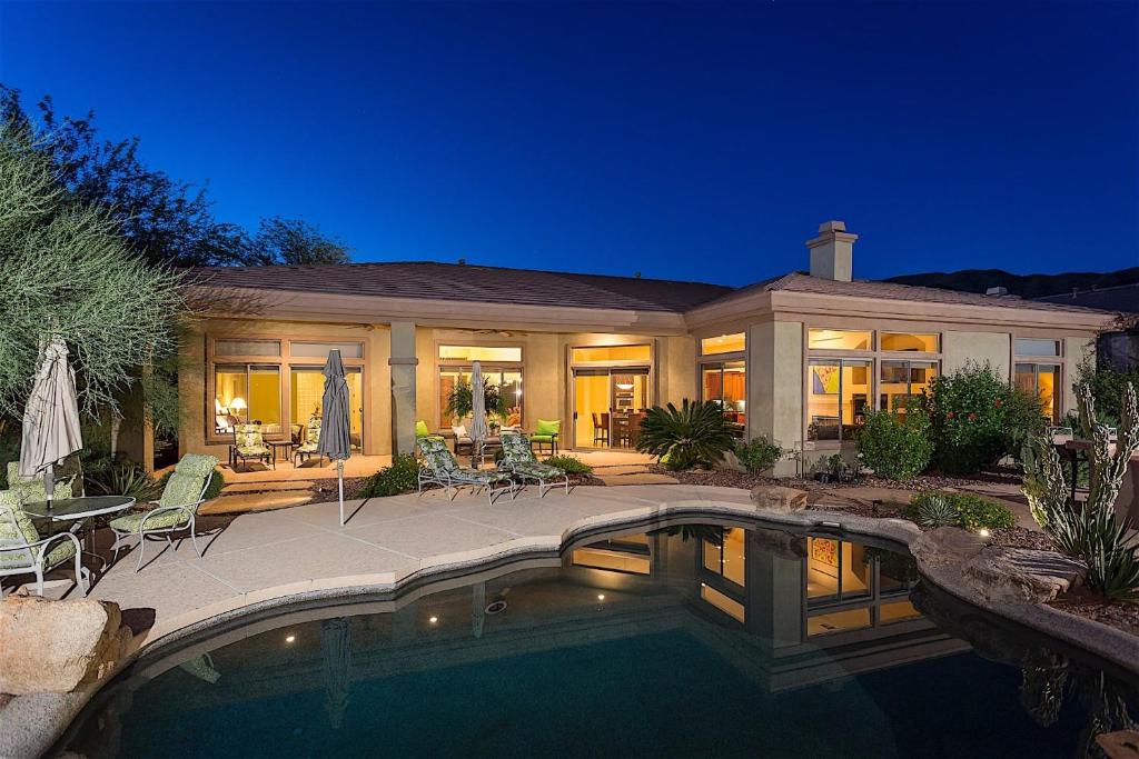 a house with a swimming pool at night at Caledonia Dreamin in Phoenix
