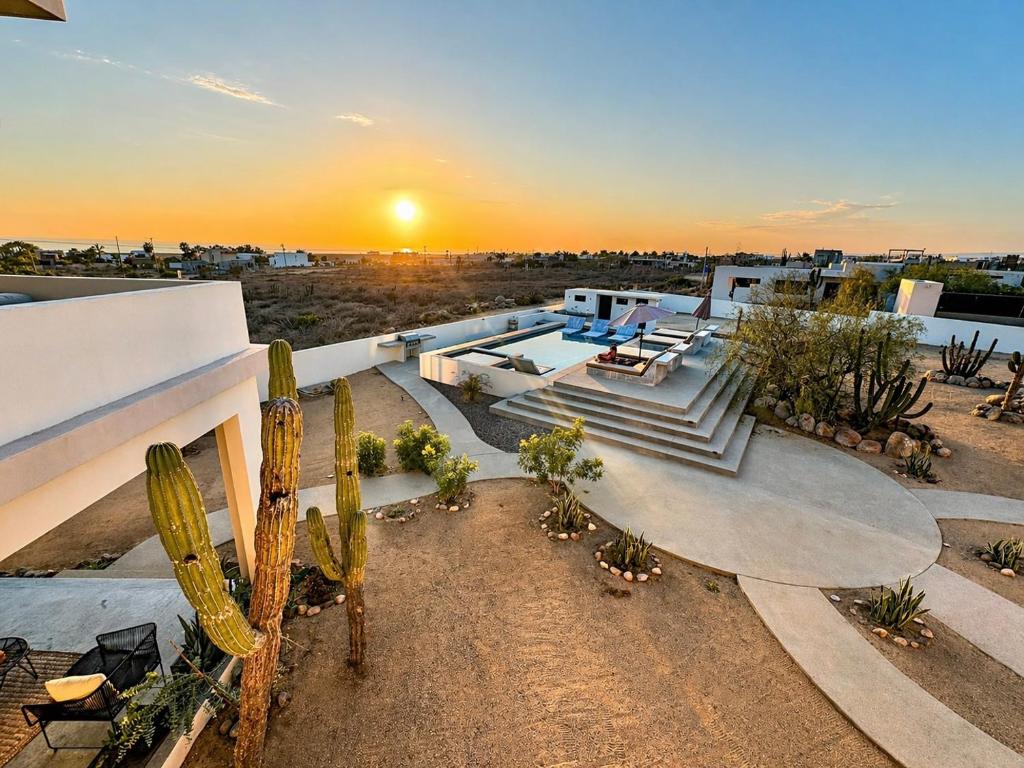 a view of a building with a sunset in the background at Sun-drenched escape w sleek saltwater pool in Todos Santos