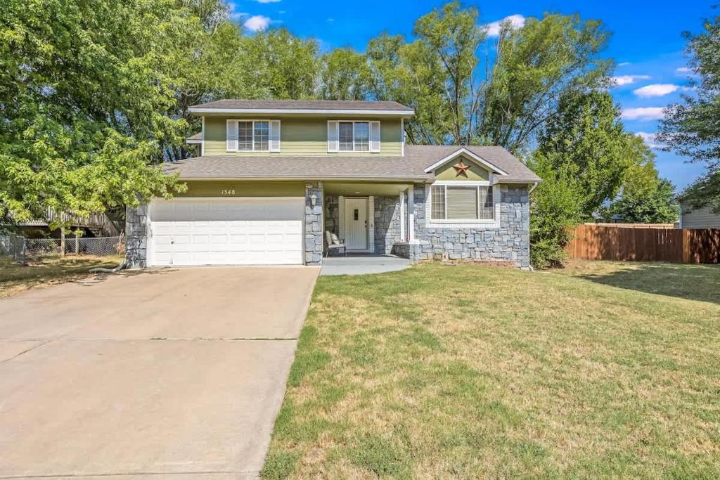 a house with a driveway in front of it at The KANtucky Derby Home in Derby