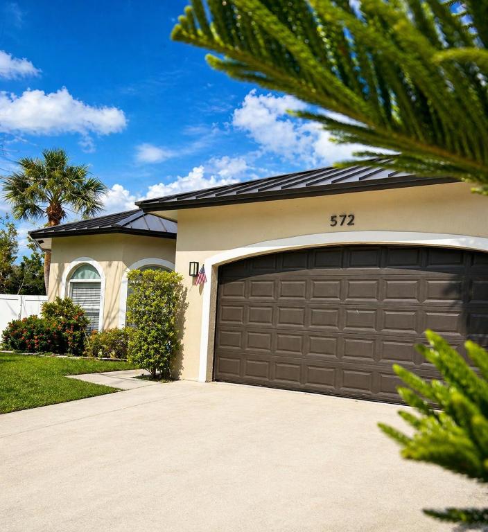 a garage door in front of a house at Peaceful Inn at Deerfield Beach Boca Raton in Deerfield Beach