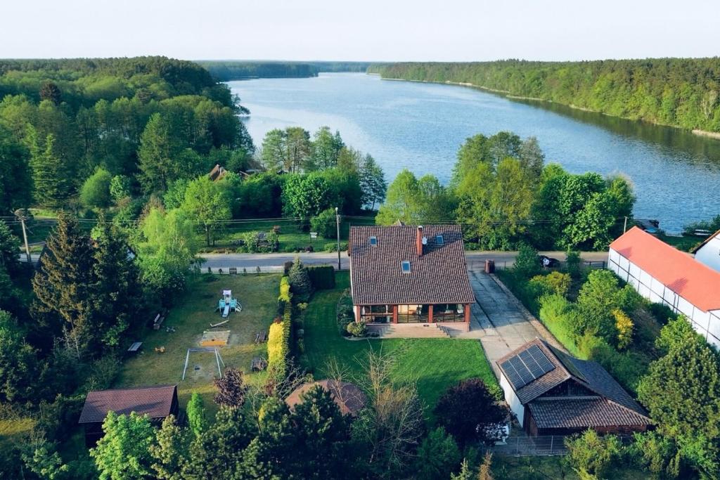 an aerial view of a house next to a river at Dom Nad Wodą - Smolarnia in Smolarnia