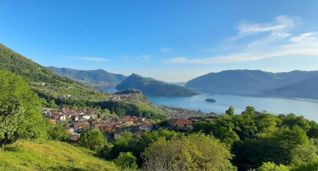 a town on a hill overlooking a body of water at Il pozzo in Marone