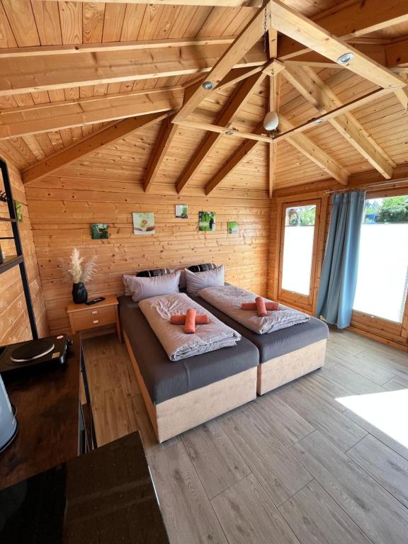 a bedroom with two beds in a wooden room at Ferienhäuser Radebeul "Sommerresidenz" in Radebeul